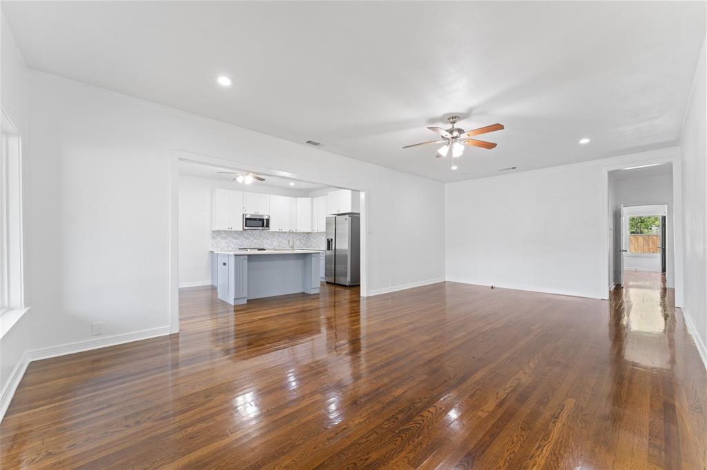 2405 Monroe Street Commerce, TX 75428 - Photo 6 of 31 a view of an empty room with a window and wooden floor