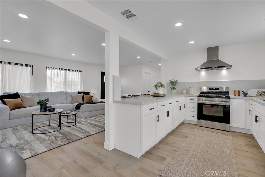 16766 Sam Gerry Drive La Puente, CA 91744 - Photo 14 of 31 a kitchen with stainless steel appliances kitchen island granite countertop a stove and a sink