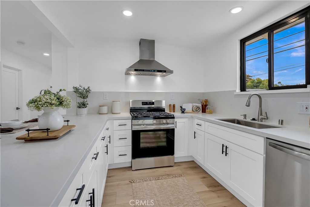 16766 Sam Gerry Drive La Puente, CA 91744 - Photo 15 of 31 a kitchen with stainless steel appliances a sink stove and cabinets