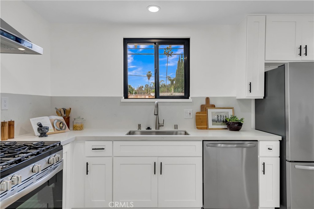 16766 Sam Gerry Drive La Puente, CA 91744 - Photo 16 of 31 a kitchen with a sink stove and refrigerator