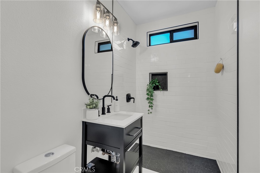 16766 Sam Gerry Drive La Puente, CA 91744 - Photo 25 of 31 a bathroom with a sink and a mirror
