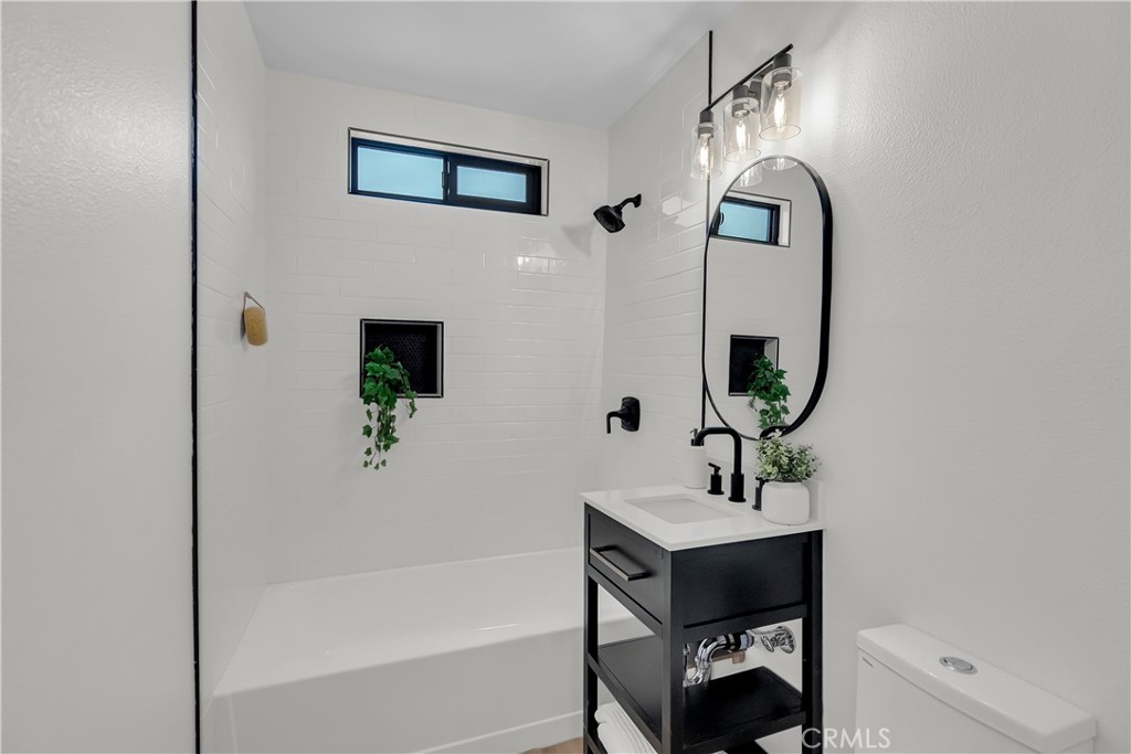 16766 Sam Gerry Drive La Puente, CA 91744 - Photo 27 of 31 a bathroom with a sink and a mirror