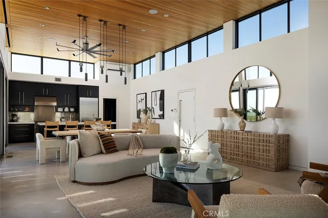 a living room with furniture a fireplace and a chandelier
