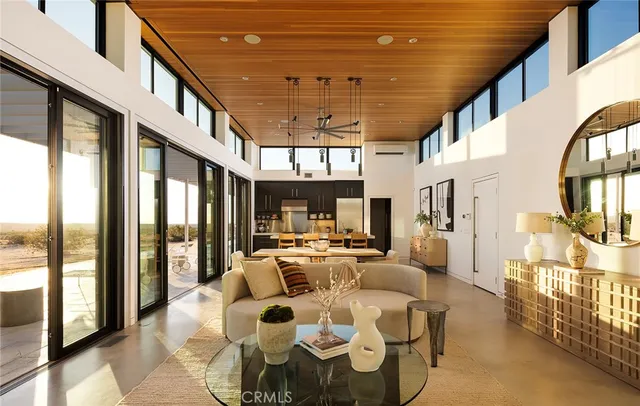 a very nice looking room with lots of furniture and a large window