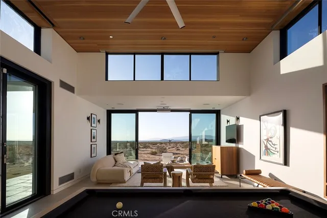 a room with furniture and large windows