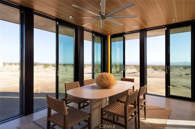 a view of a dining room with furniture and window