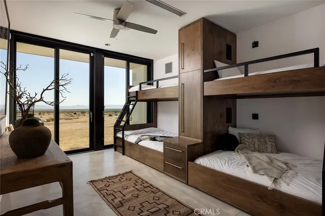 a bedroom with a bed a large window and walk in closet