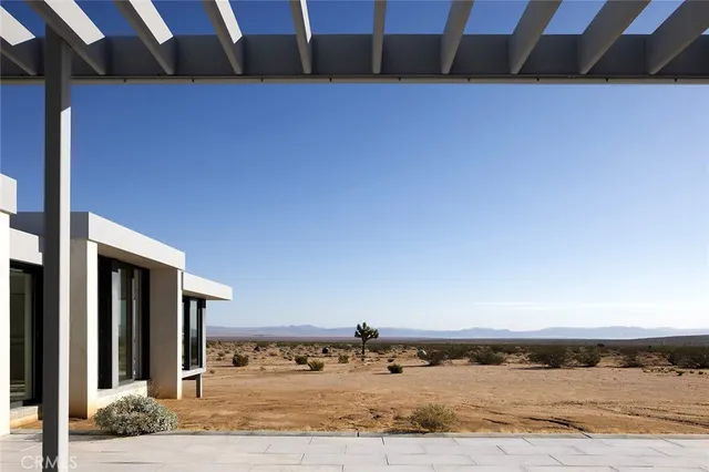 a view of a house with a wooden fence
