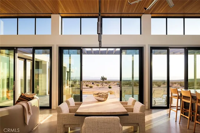 a living room with furniture city view and large windows