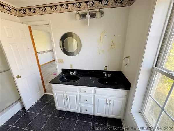 a white cabinet with a sink and a mirror