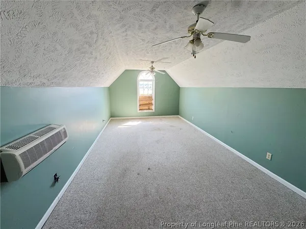 a view of a room with entryway fan and windows