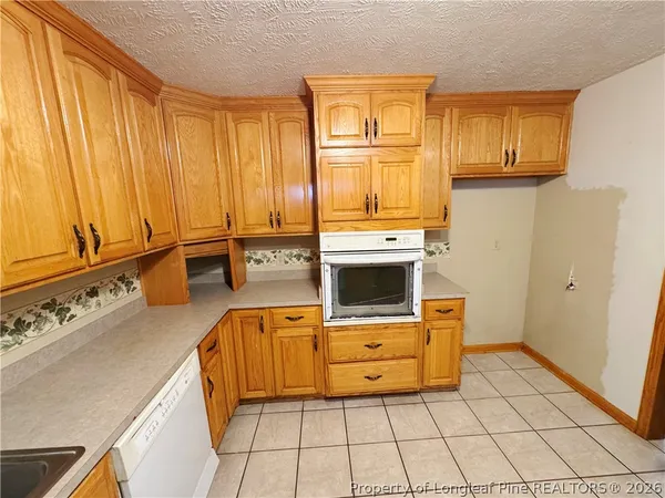 a kitchen with stainless steel appliances a stove sink and cabinets