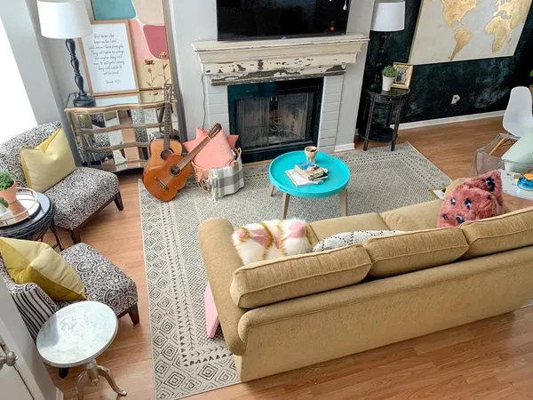 a living room with furniture and a fireplace