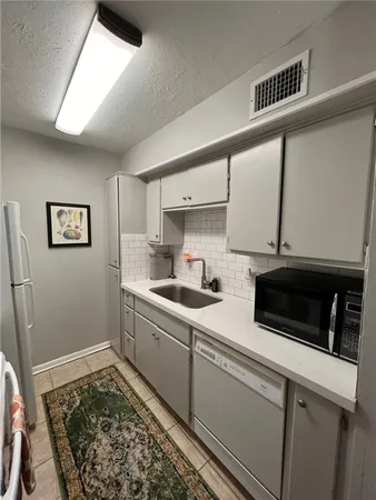 a kitchen with stainless steel appliances a stove a sink and a refrigerator