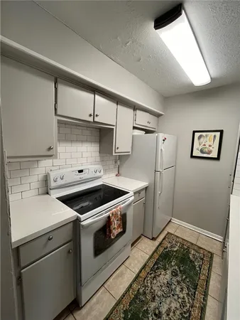 a kitchen with a stove and a refrigerator