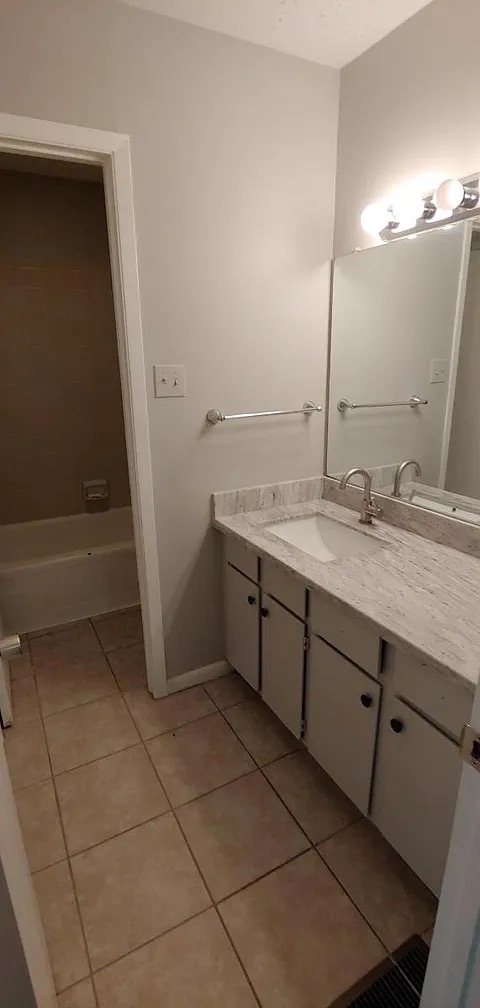 4441 Old College Road, Unit 5204 Bryan, TX 77801 - Photo 10 of 14 a bathroom with a granite countertop sink and a mirror