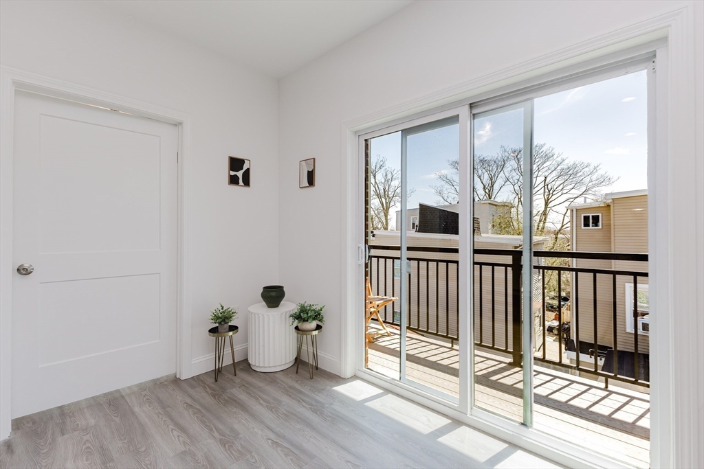 92-94 George Street, Unit 202 Boston, MA 02119 - Photo 11 of 42 a view of a room with wooden floor and windows