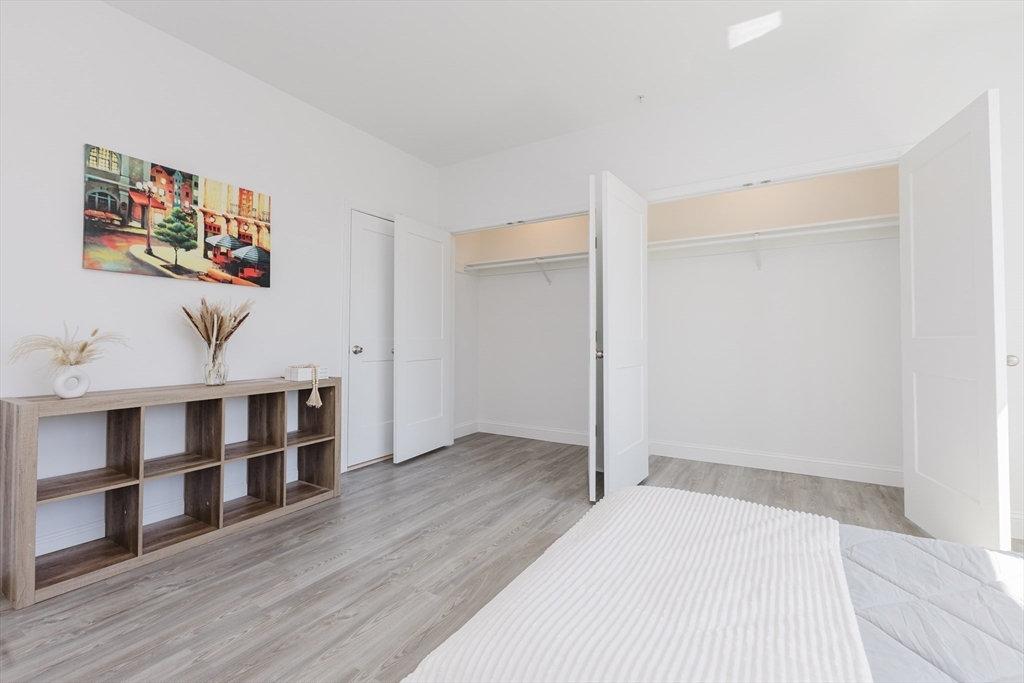 92-94 George Street, Unit 202 Boston, MA 02119 - Photo 25 of 42 a view of a bedroom with wooden floor and window