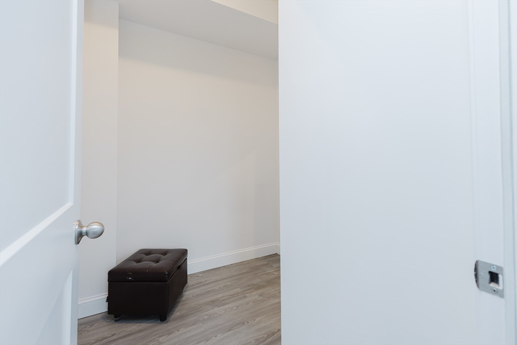 92-94 George Street, Unit 202 Boston, MA 02119 - Photo 33 of 42 a room with a black white wall and a white cabinet