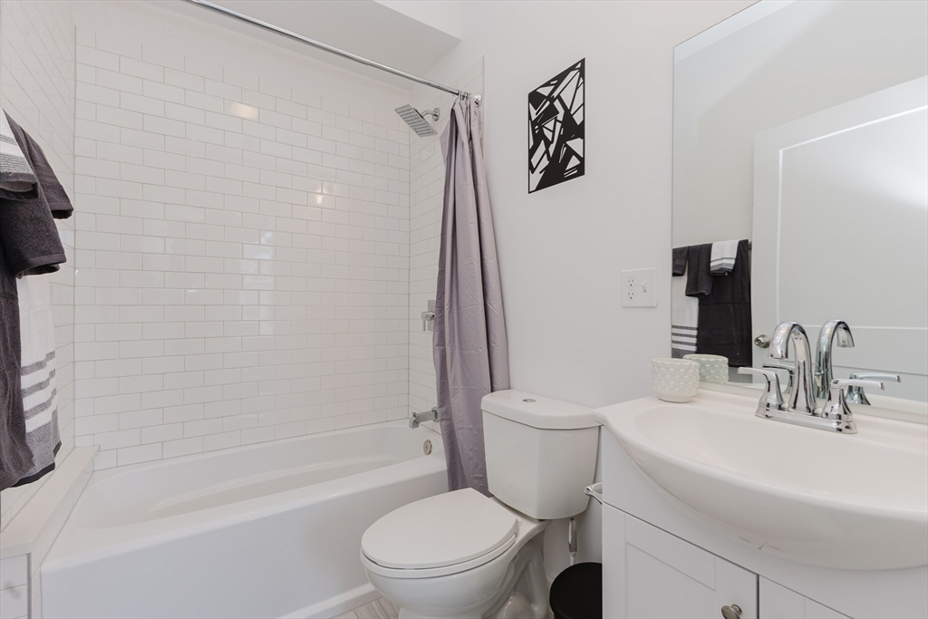 92-94 George Street, Unit 202 Boston, MA 02119 - Photo 35 of 42 a bathroom with a sink toilet and shower