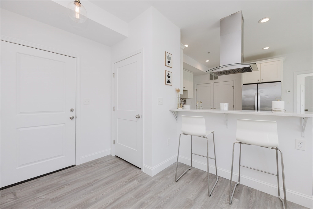 92-94 George Street, Unit 202 Boston, MA 02119 - Photo 9 of 42 a kitchen with a sink cabinets and wooden floor