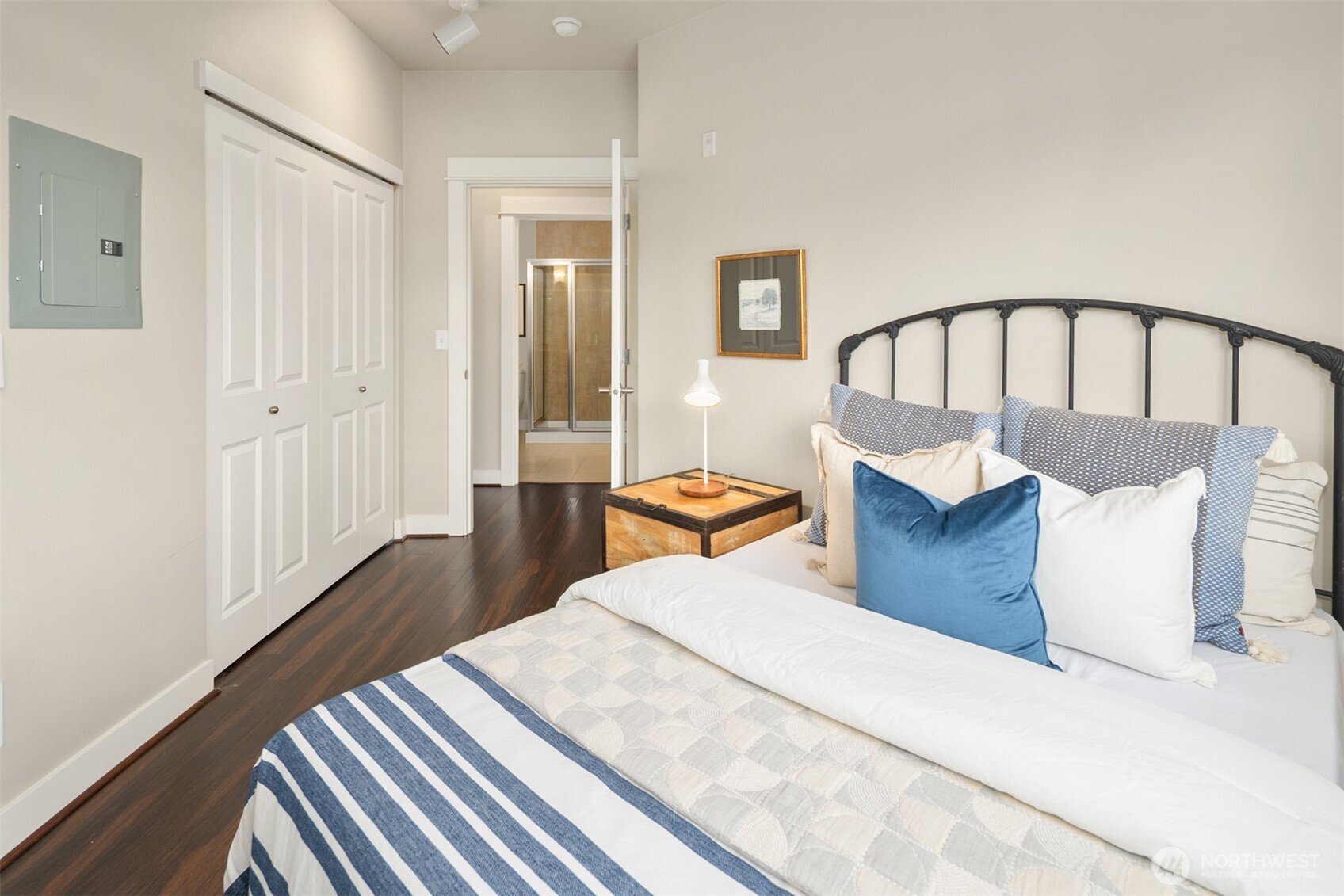 15700 116th Avenue Northeast, Unit 404 Bothell, WA 98011 - Photo 18 of 31 a bedroom with a bed and wooden floor