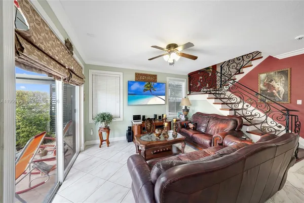 a living room with furniture a chandelier and a window