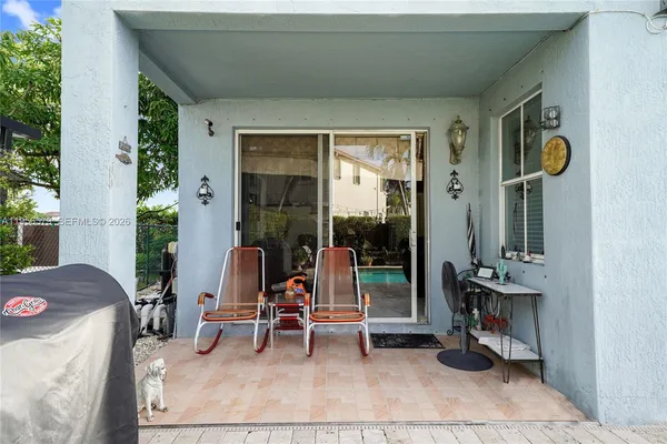 a backyard of a house with table and chairs