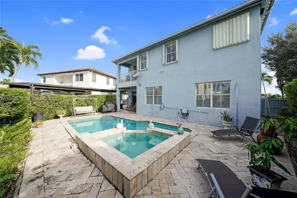 a view of a house with swimming pool and sitting area