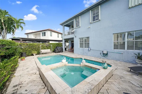 a view of a storage and utility room with washer and dryer
