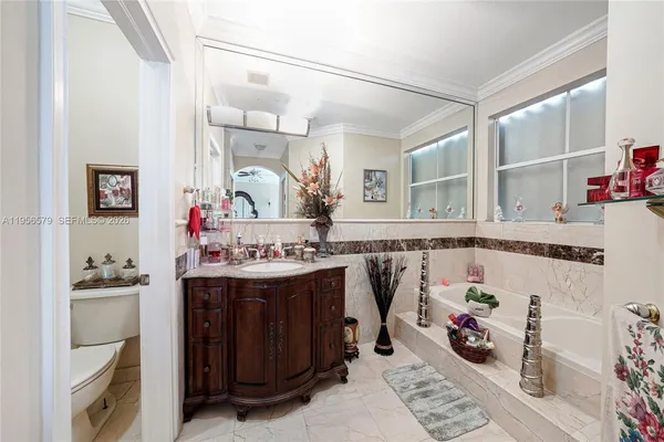a bathroom with a sink vanity and a mirror