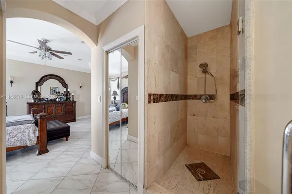 a view of a white house with a big yard and potted plants