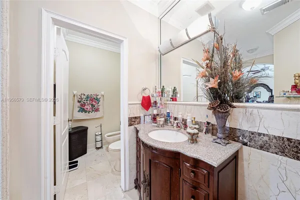 a front view of a house with a garden and plants