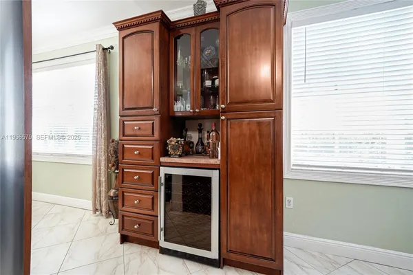 a view of kitchen with stainless steel appliances granite countertop cabinets and a window