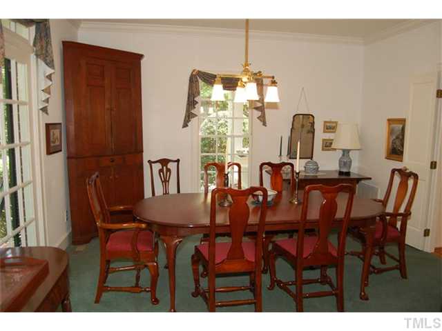 Formal dining can be enjoyed in this spacious yet elegant showplace accented by transom windows and heavy custom moldings.