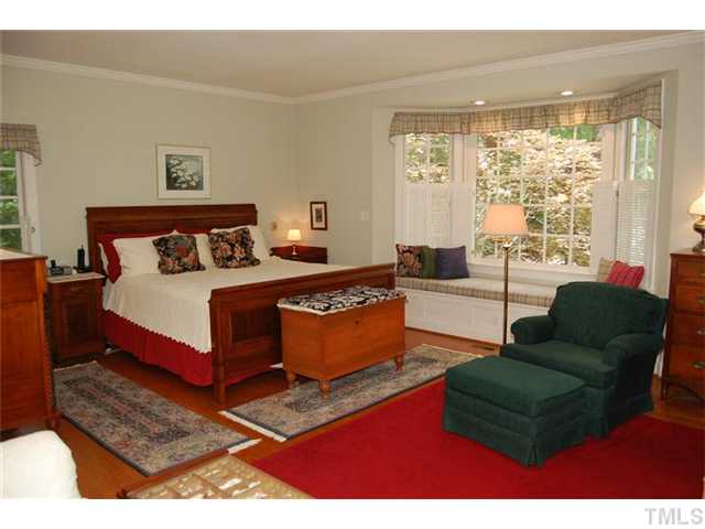 First floor owners? suite right out of Southern Living! Lovely bay window with sitting area brings the outside in, all year round.  More warm yellow pine floors.