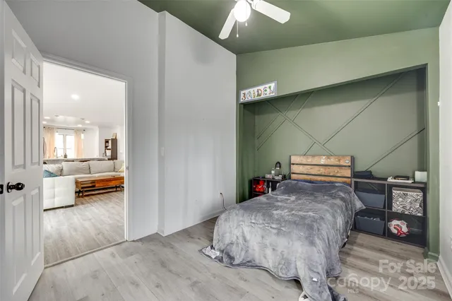 a bedroom with bed and a large mirror