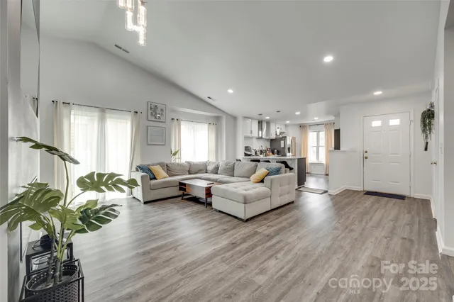 a living room with furniture and a wooden floor