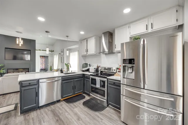 a kitchen with stainless steel appliances and wooden cabinets
