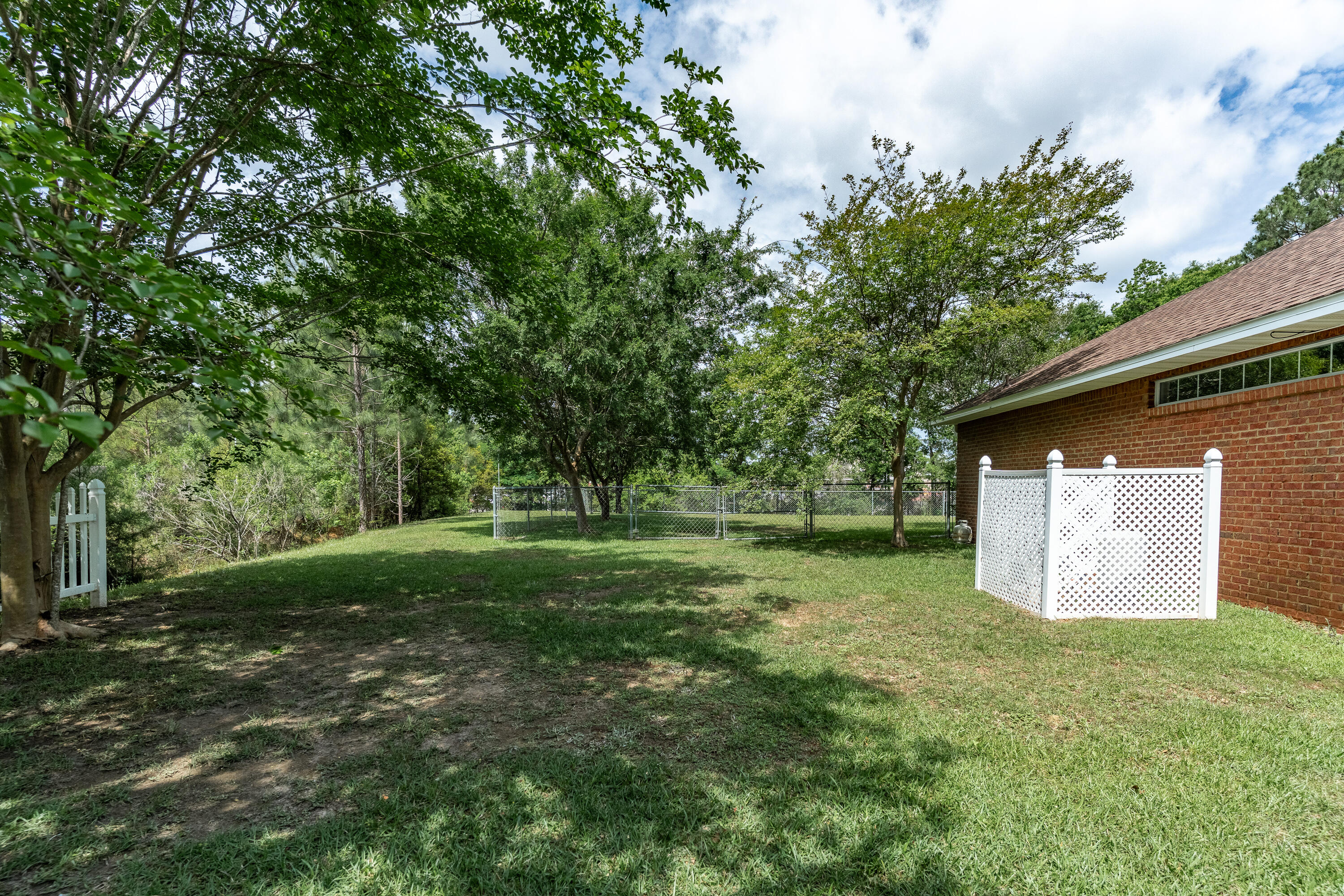 6100 Buckward Road Baker, FL 32531 - Photo 6 of 55 a view of a backyard with large trees
