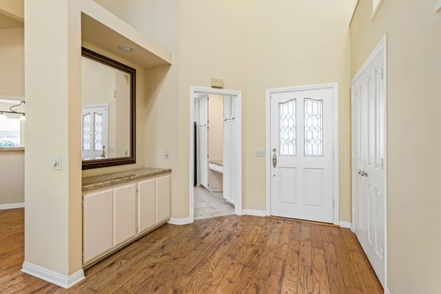 a view of a hallway with wooden floor and closet
