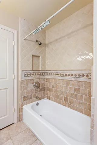 a bathroom with a bathtub and shower
