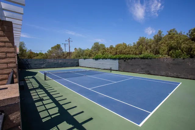 a view of an outdoor space and tennis court