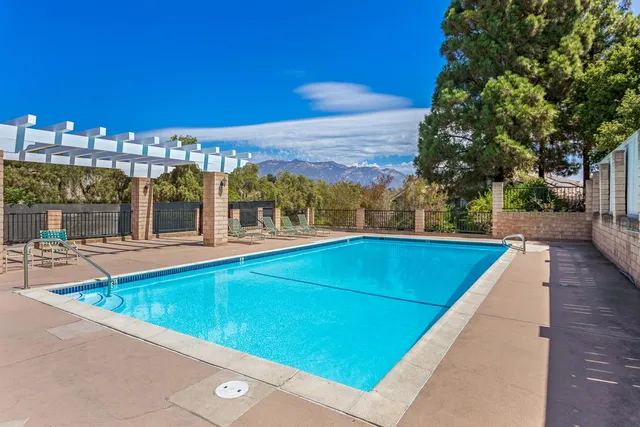 a view of swimming pool with a chairs