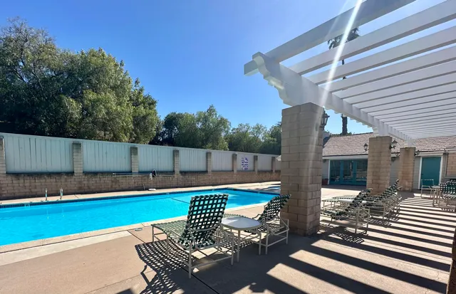 a view of a chairs and table in the patio