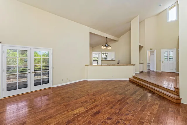 a view of a room with wooden floor and windows