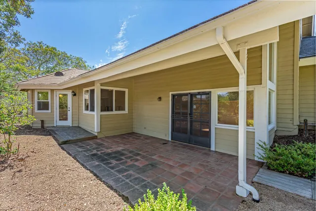 a front view of a house with a garden