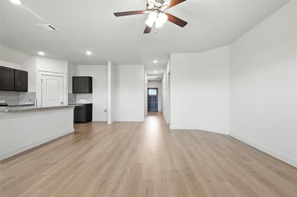 1795 Gleasondale Place Forney, TX 75126 - Photo 11 of 29 Unfurnished living room with ceiling fan, recessed lighting, and light wood-type flooring