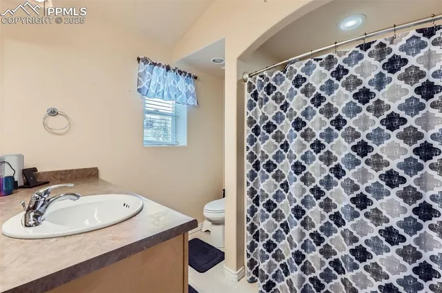 a bathroom with a sink toilet and a mirror