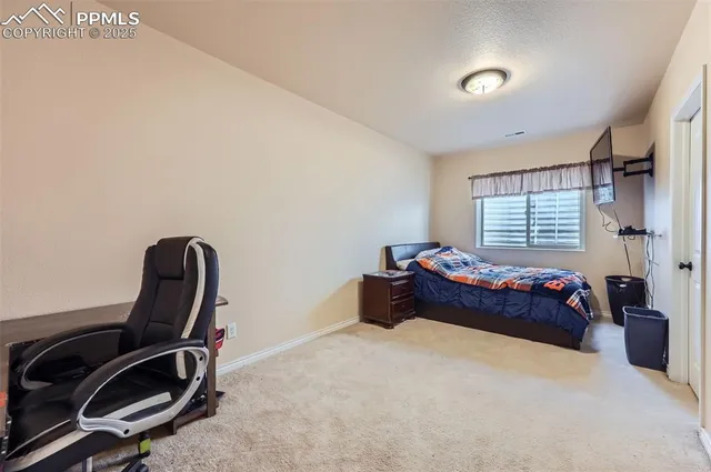 a bedroom with a bed and a chair